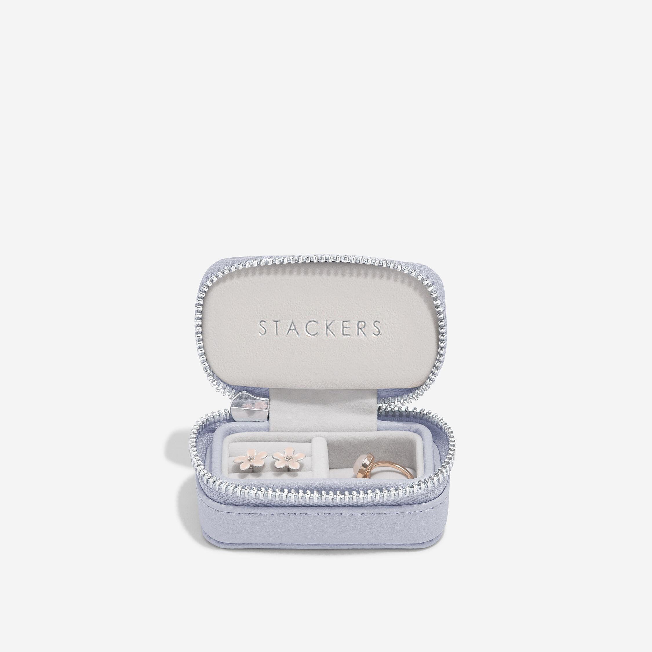 Open jewelry box with earrings inside on a white background