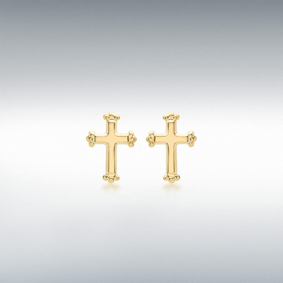 Gold cross-shaped earrings for children on a light gray background