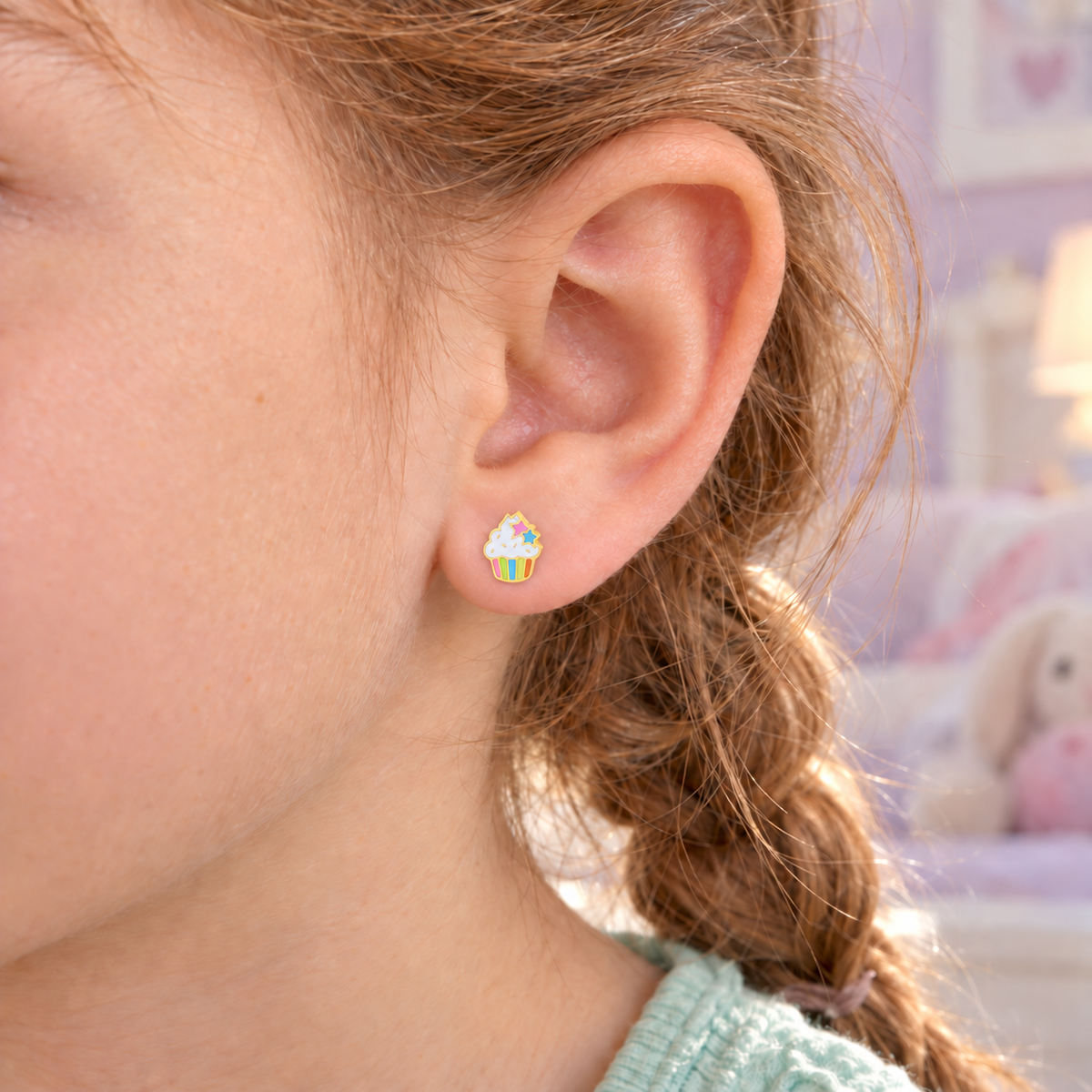 Cupcake hypoallergenic earring worn in a child’s ear, designed for sensitive ears