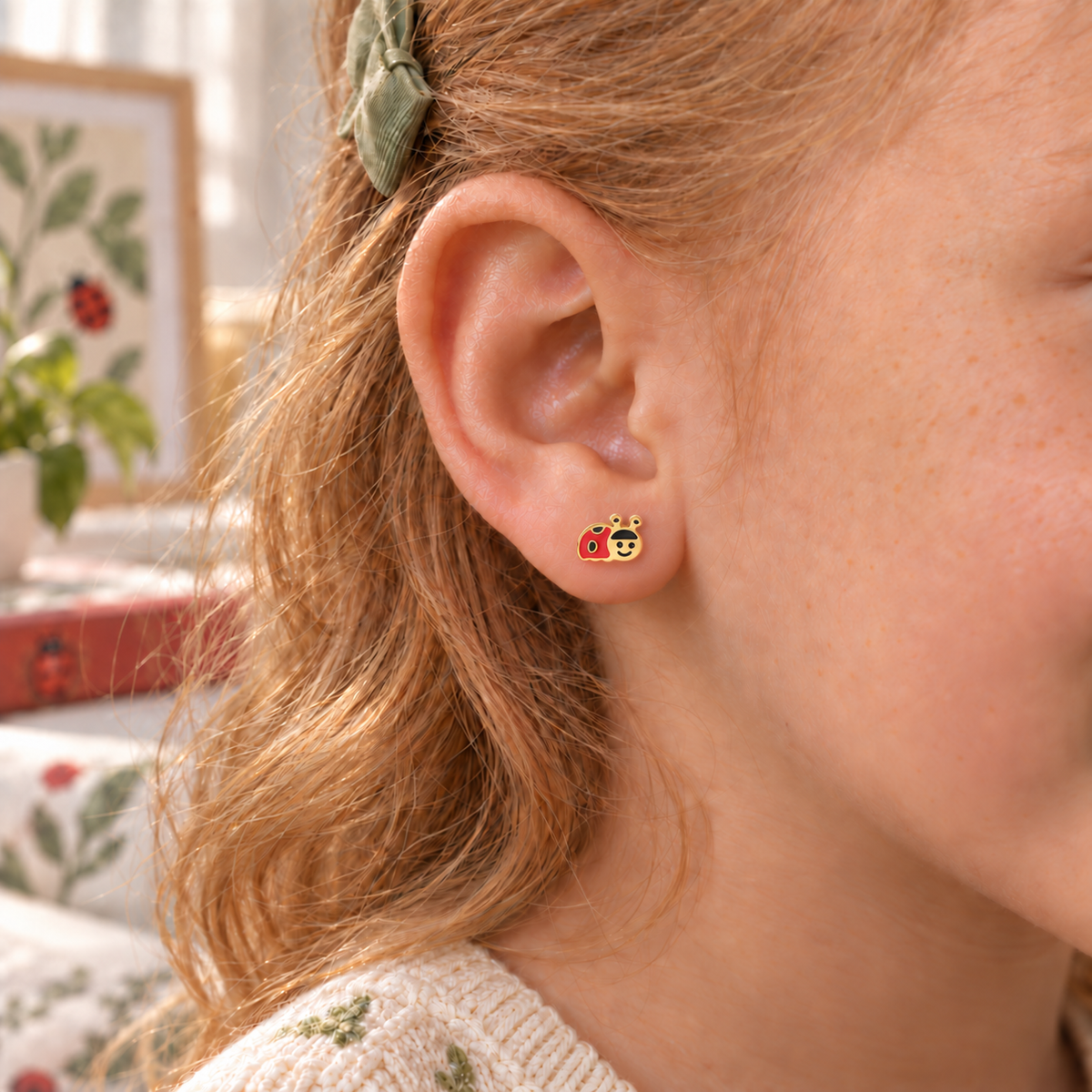 Ladybird hypoallergenic earring worn in a child’s ear, designed for sensitive ears
