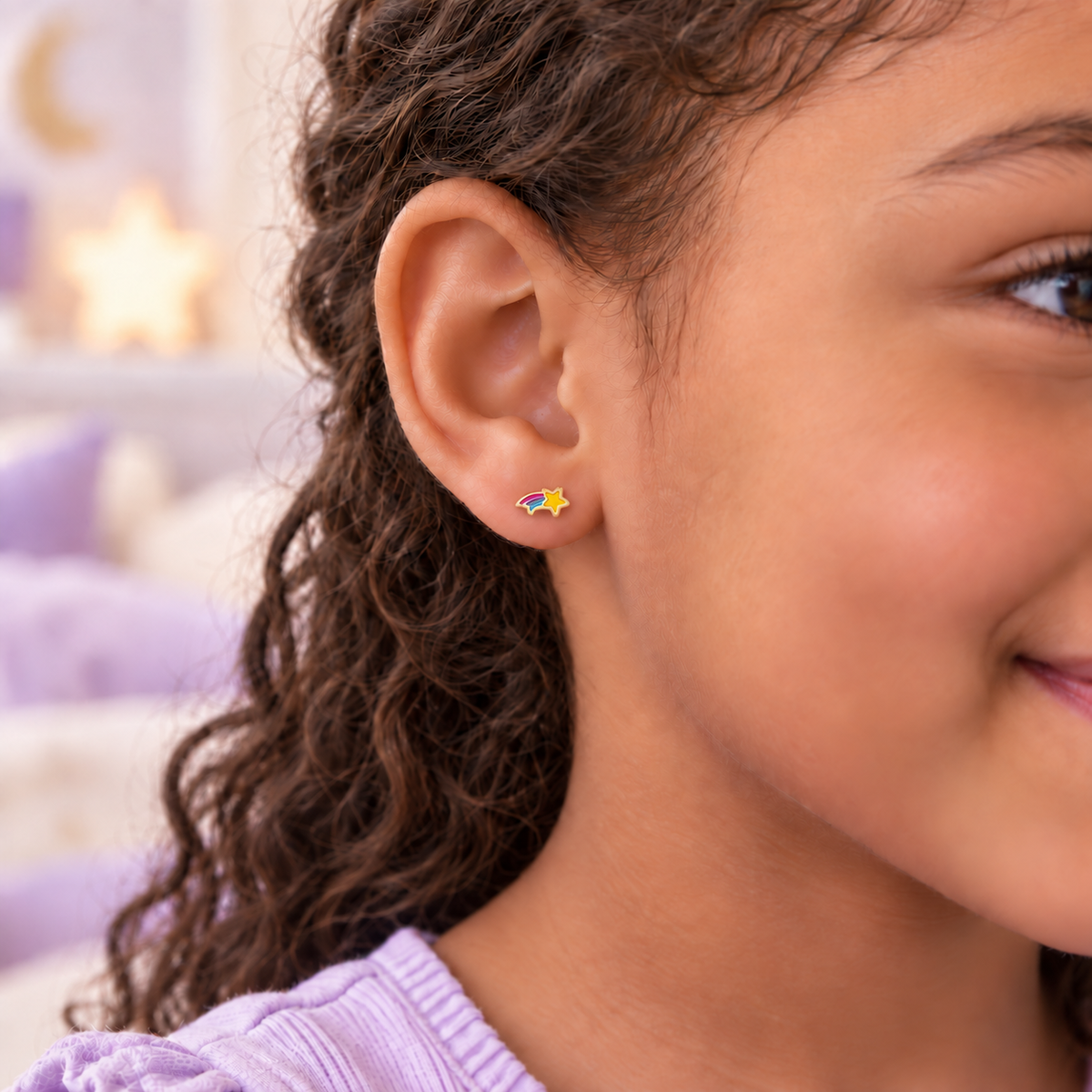 Gold rainbow shooting star hypoallergenic flat back earring worn in a child’s ear