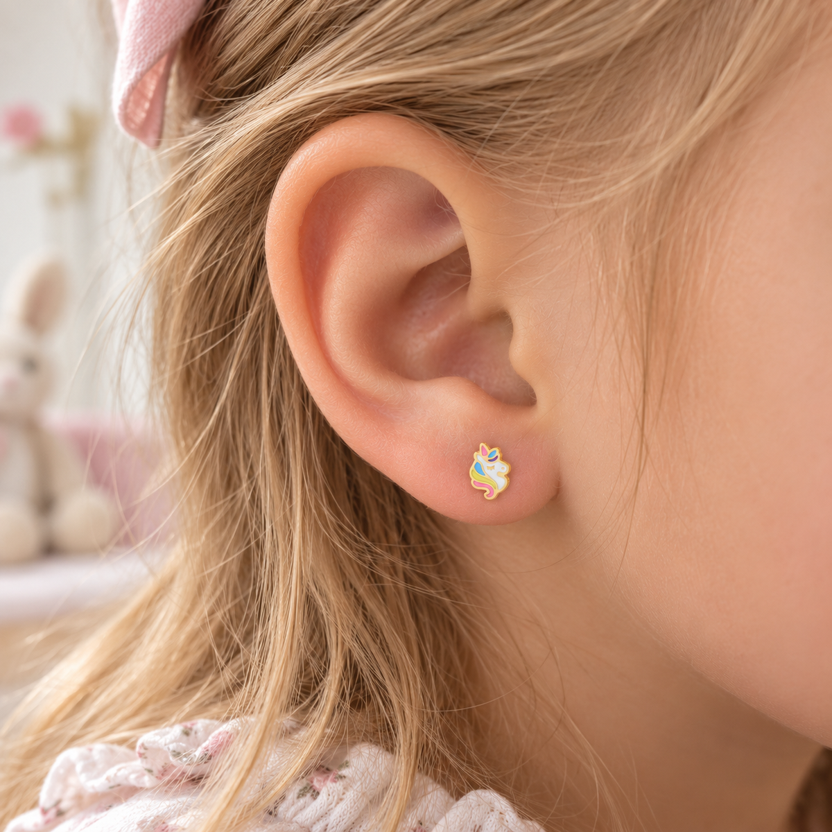 Unicorn hypoallergenic earring worn in a child’s ear, designed for sensitive ears